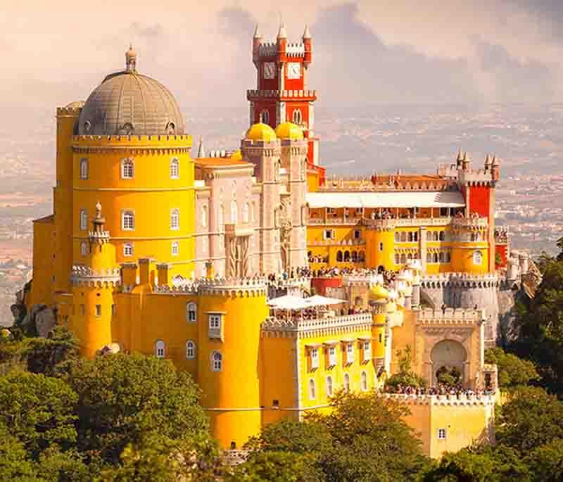 Pena Palace - A colorful palace in Sintra blending Gothic, Renaissance, and Moorish styles, set in a lush park.