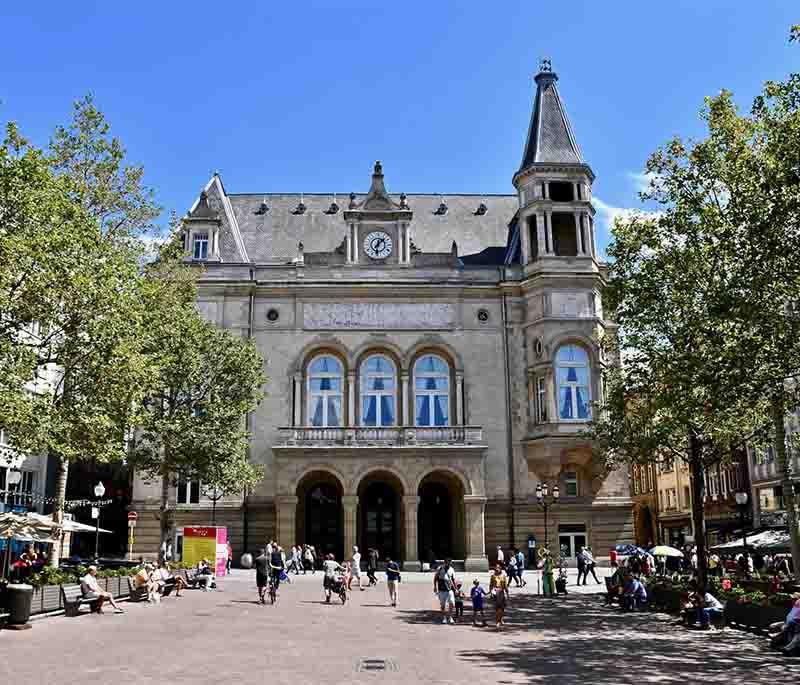 Place d'Armes, a lively square in Luxembourg City, surrounded by cafes, restaurants, and historic buildings.