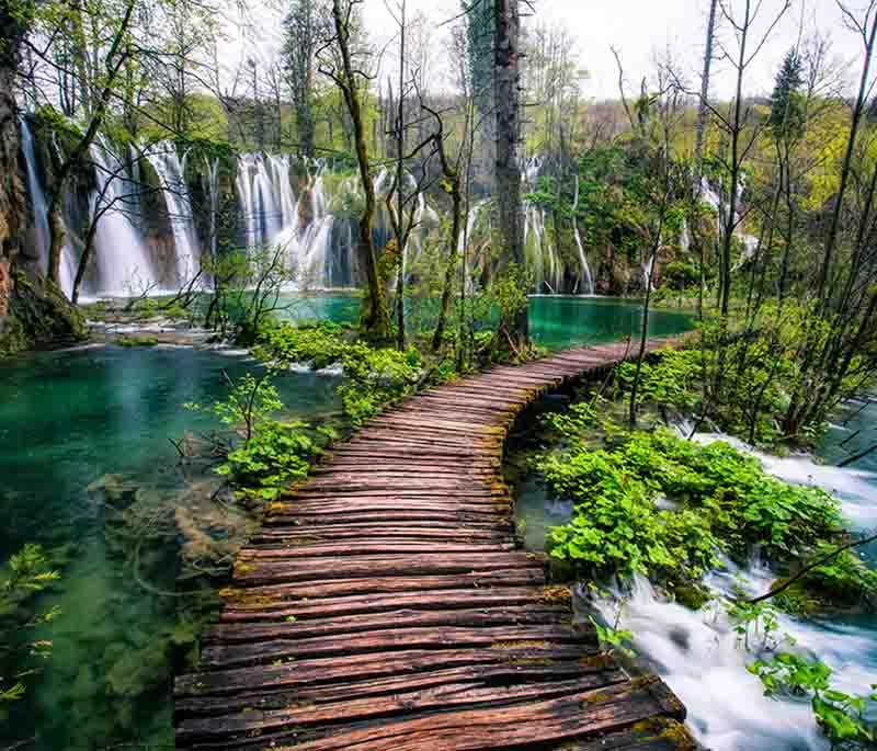 Plitvice Lakes National Park, a UNESCO World Heritage site, featuring cascading lakes, stunning waterfalls, and lush forests.