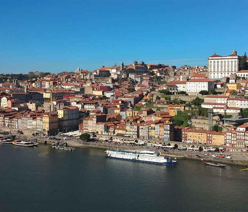 Porto - Famous for port wine production, scenic Douro River, and charming Ribeira district with colorful buildings.