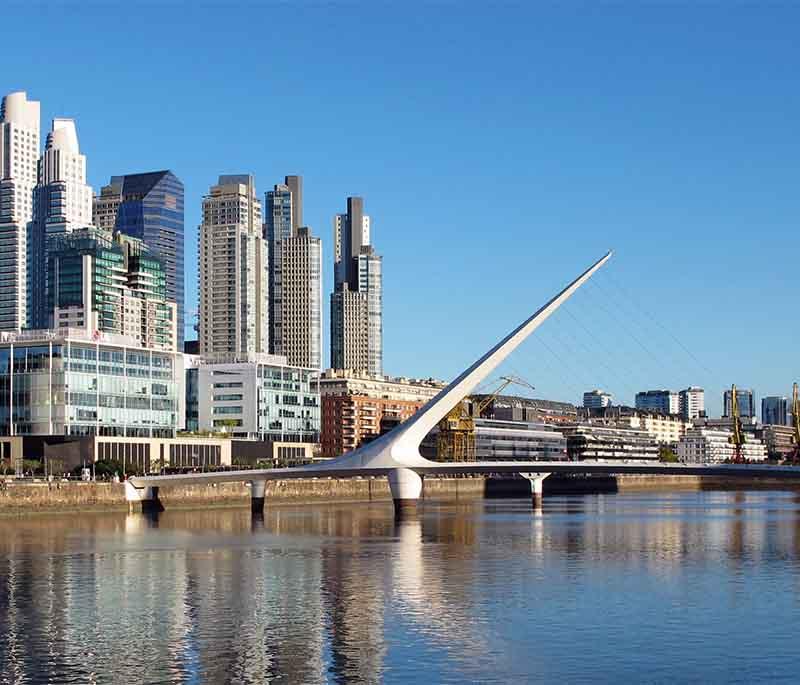 Puerto Madero in Buenos Aires, depicting modern skyscrapers and upscale restaurants along the revitalized waterfront, chic.