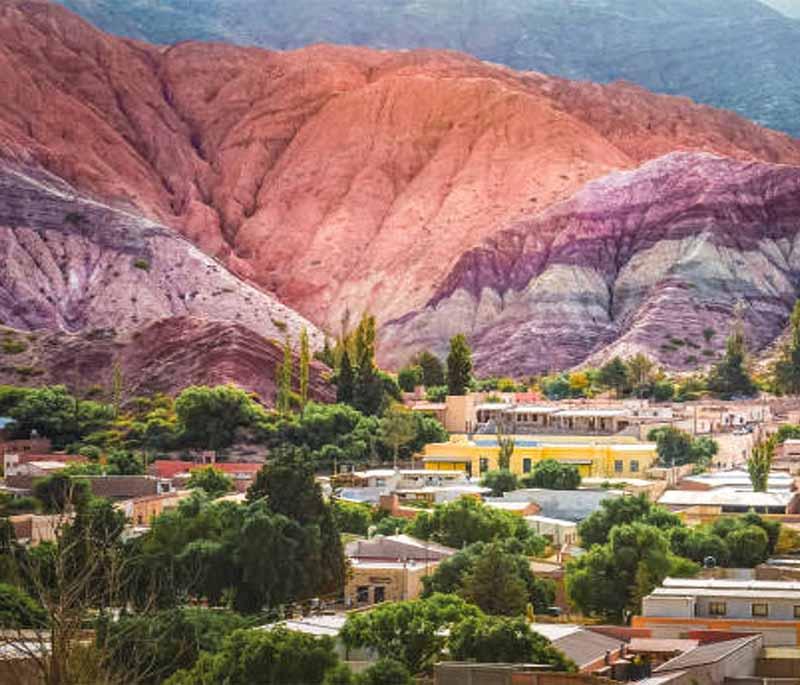 Purmamarca, Jujuy: Featuring a small village set against the backdrop of multicolored mountains, vibrant and picturesque.