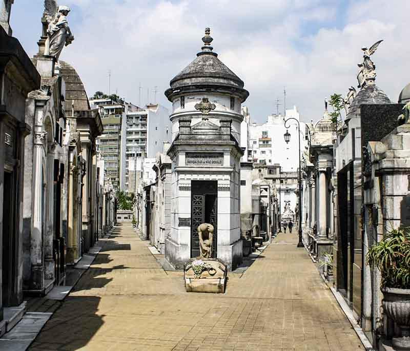 Recoleta Cemetery in Buenos Aires, showcasing elaborate mausoleums and historic tombs in a serene setting, very peaceful.