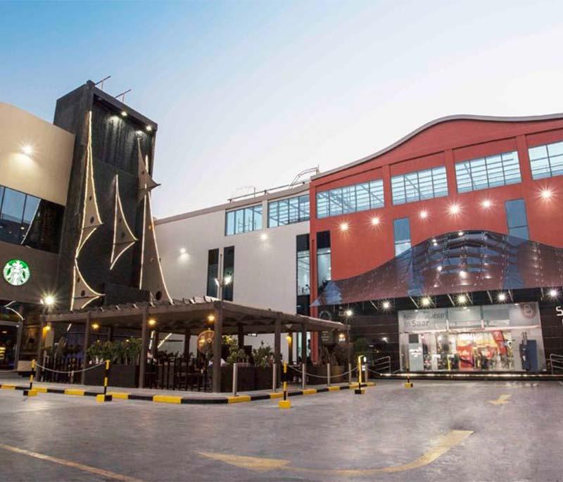 Saar Mall, presenting a neighborhood shopping center with a variety of stores, services, and lively atmosphere.