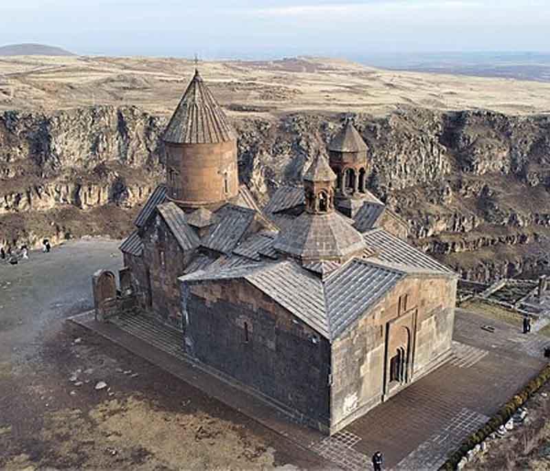 Saghmosavank Monastery, depicting a historic monastery perched on the edge of a deep gorge with sweeping views.