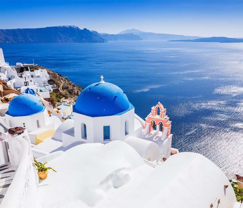 Santorini, a picturesque island in the Aegean Sea known for stunning sunsets, white-washed buildings, and volcanic beaches.