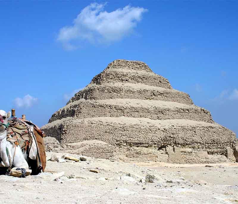 Saqqara Pyramids and Necropolis, home to the Step Pyramid of Djoser, the oldest stone pyramid, and numerous ancient tombs.