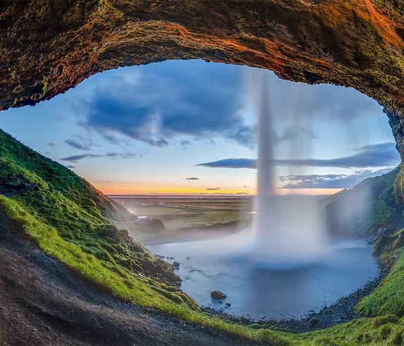 Seljalandsfoss Waterfall, a unique waterfall that visitors can walk behind, offering a one-of-a-kind experience.