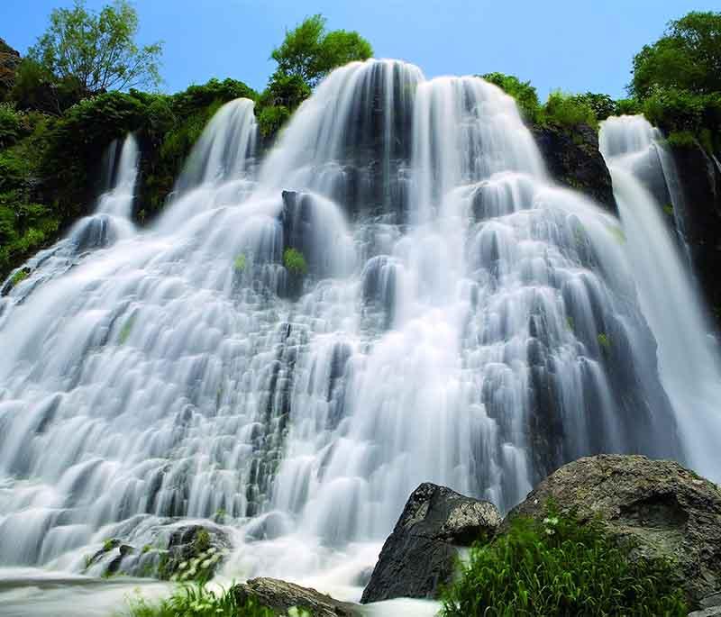 Shaki Waterfall, presenting a stunning waterfall known for its picturesque setting in the forest and serene spot.