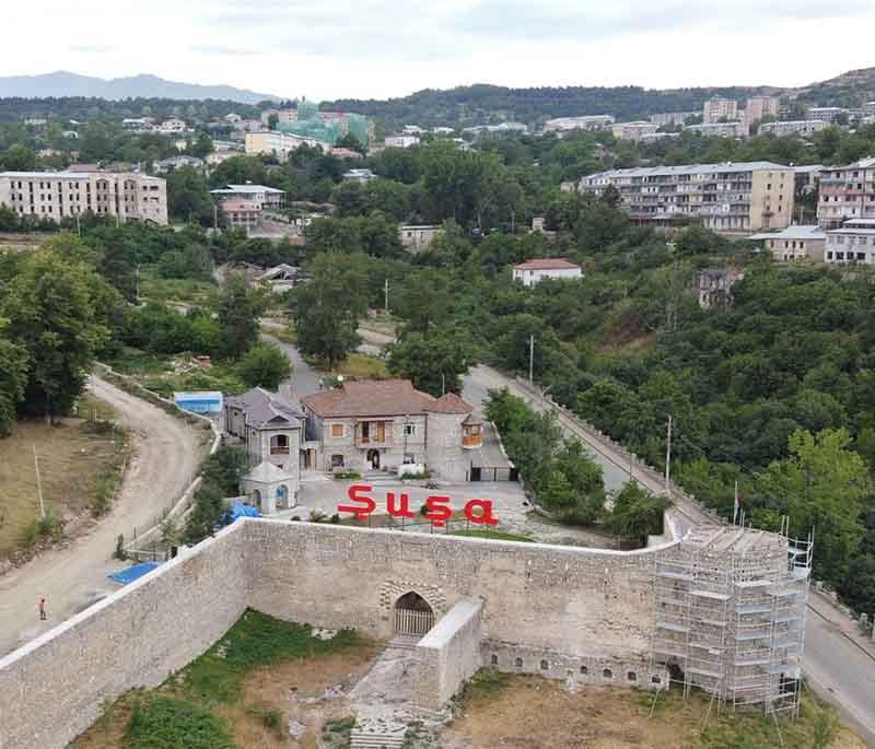 Shusha City, depicting the historical city with a rich cultural background, recently reclaimed and undergoing restoration.