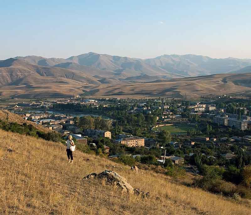 Sisian, depicting a town rich in historical monuments and surrounded by rugged natural beauty and heritage.