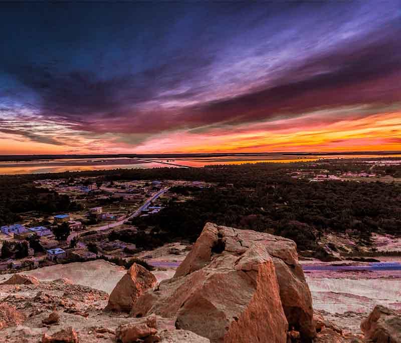 Siwa Oasis, a remote and picturesque oasis known for its natural springs, salt lakes, and the ancient Oracle of Amun.