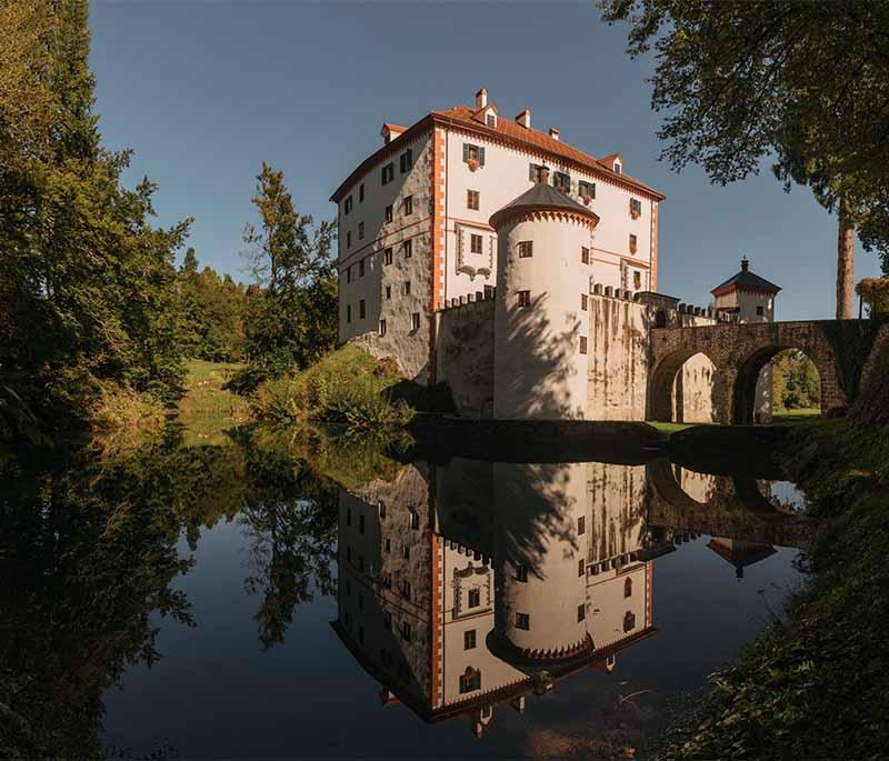 Snežnik Castle - A romantic castle located in a scenic setting, surrounded by forests, lakes, and serene landscapes.