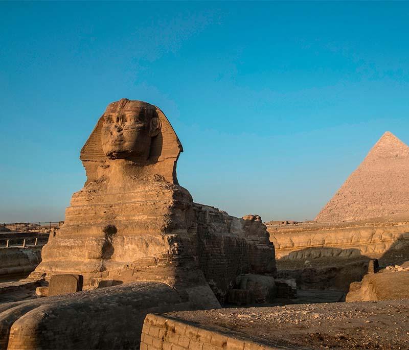 Sphinx, a monumental limestone statue with a lion's body and a human head, symbolizing royal power and protection.