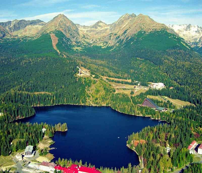 Štrbské Pleso - A mountain resort offering skiing in winter and hiking in summer, located by a picturesque alpine lake.
