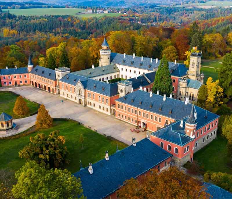 Sychrov Castle, a neo-Gothic chateau known for its beautiful interiors, extensive art collections, and picturesque park.