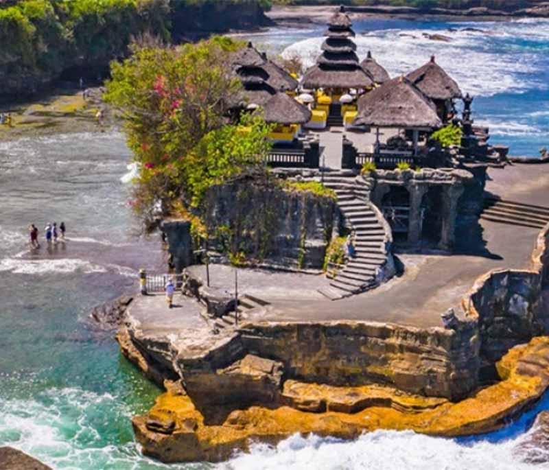 Tanah Lot Temple, Bali, a famous sea temple located on a rock formation, known for its stunning sunset views.