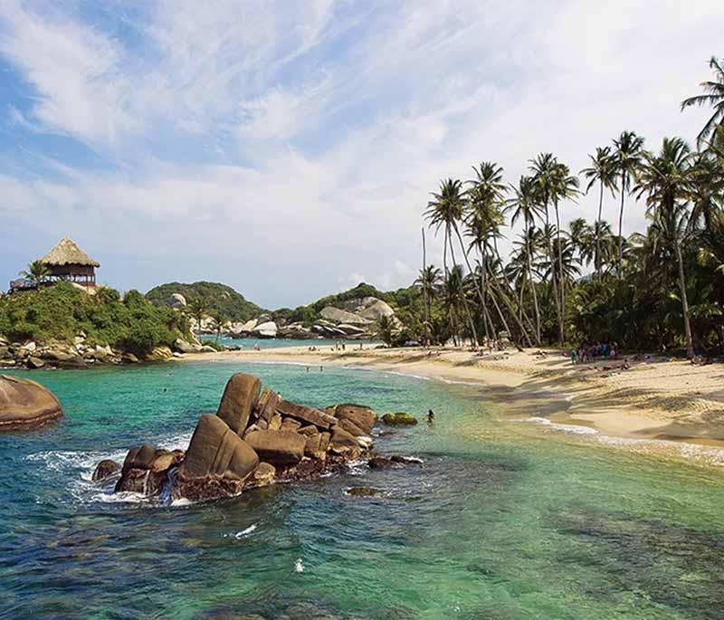 Tayrona National Park, showcasing pristine beaches, lush jungles, and indigenous history, ideal for nature lovers.