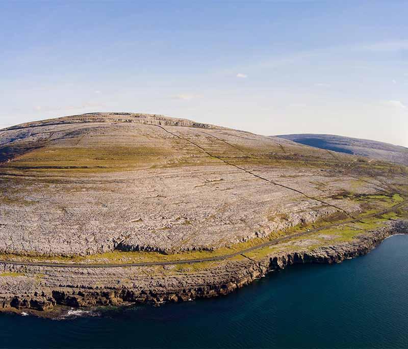 The Burren, County Clare, a unique karst landscape with rich flora, ancient tombs, and beautiful coastal views.