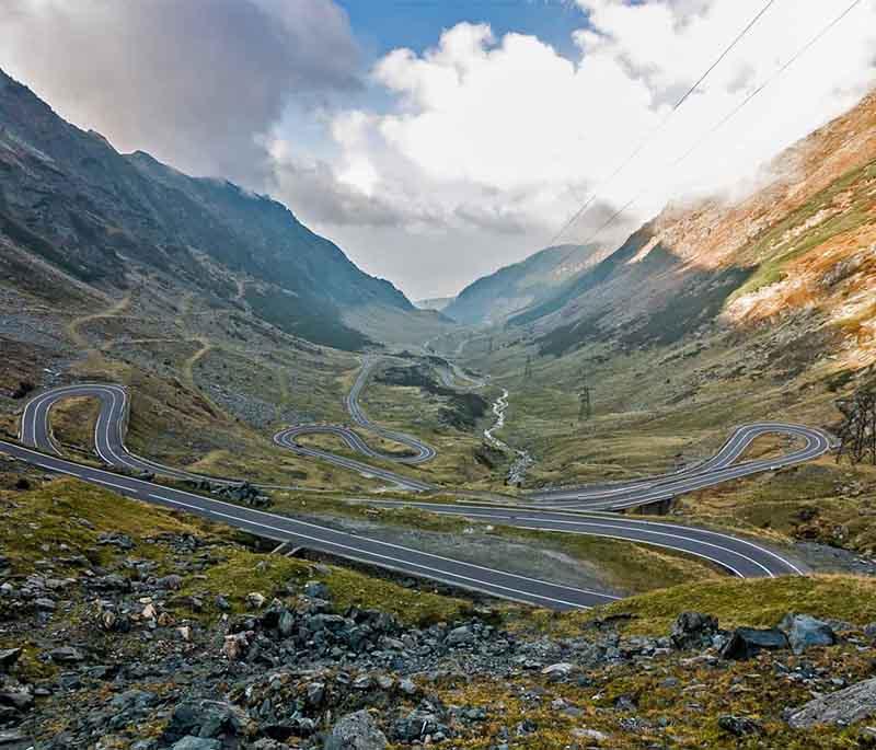 Transfăgărășan Highway - Scenic mountain road through Făgăraș Mountains, offering breathtaking views and hairpin turns.