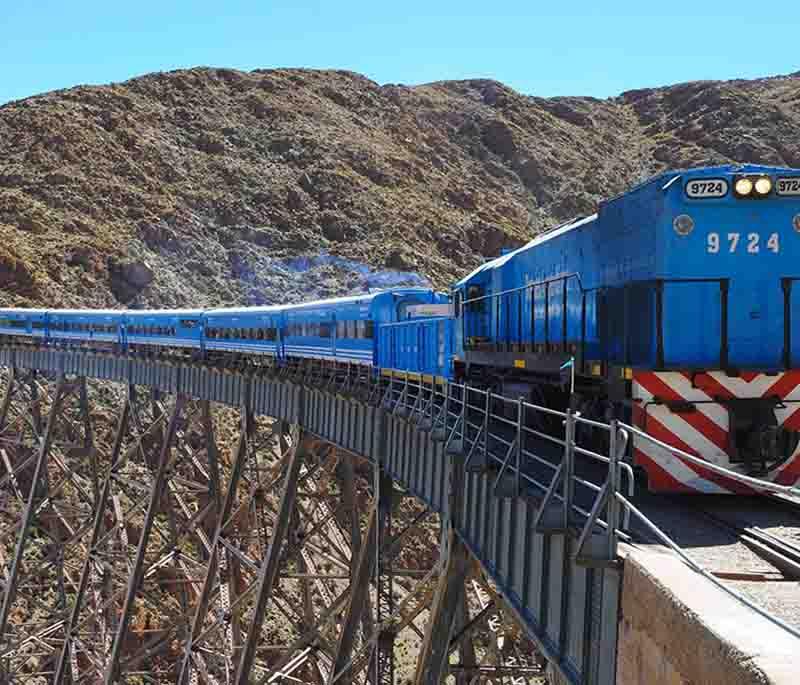 Tren a las Nubes, Salta: Depicting a train journey across high bridges and mountainous terrain, a scenic adventure.