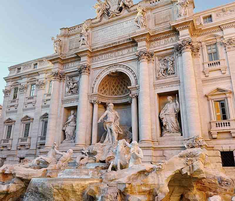 Trevi Fountain, Rome, a stunning Baroque fountain where visitors toss coins to ensure their return to Rome.