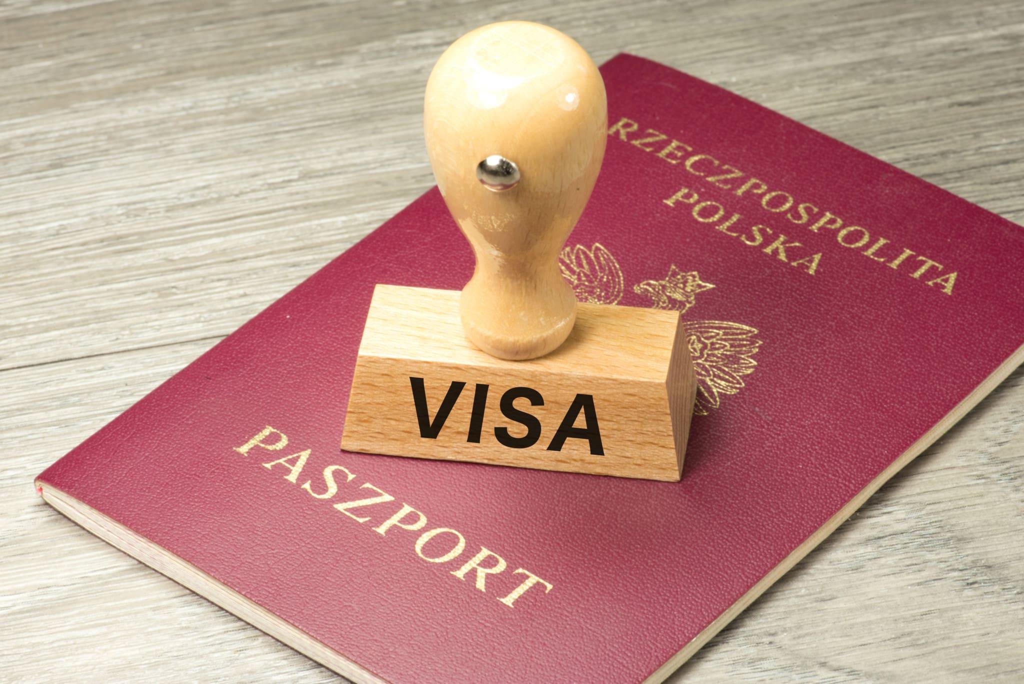 Poland reduces foreign work visas by 33% following a scandal, tightening immigration policies amid controversy.