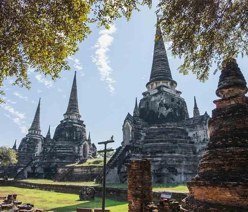 Wat Mahathat, Ayutthaya - A historic temple known for its Buddha head entwined in tree roots, and rich history.