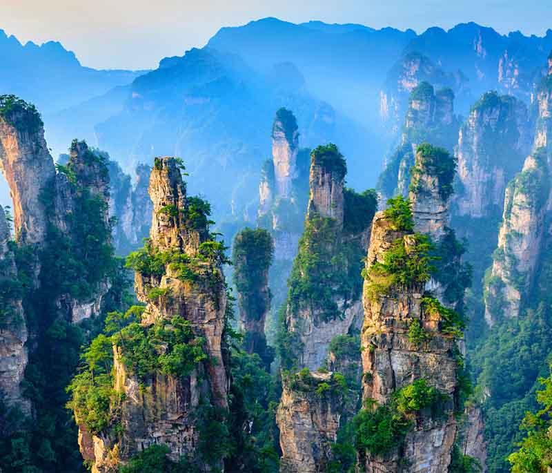 Wulingyuan Scenic Area in Hunan features thousands of sandstone pillars and is recognized as a UNESCO World Heritage site.