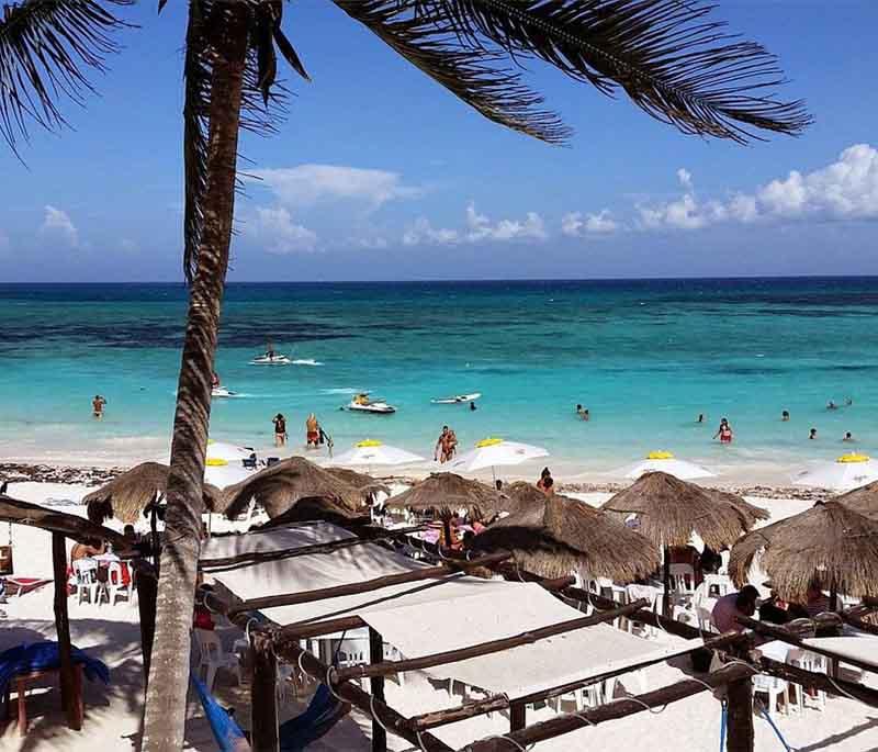 Xpu-Ha Beach, Quintana Roo - Lesser-known gem, crystal clear waters, relaxed atmosphere, sunbathing.