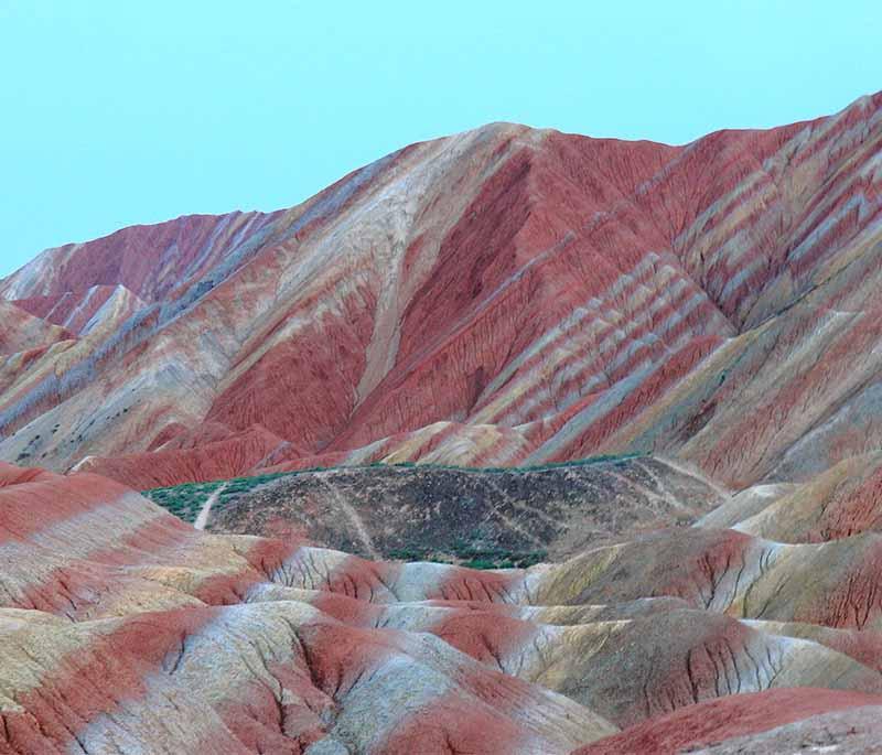 Zhangye Danxia Landform in Gansu is noted for its colorful rock formations, described as a layer cake of minerals.